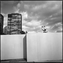 A statue, "We shall beat swords into plowshares" by Evgeny Vuchetich, a gift from the Soviet Union in 1959, stood in the United Nations garden behind a wall where work is being done for a new building at the United Nations site.  The Upper East side stood in the background